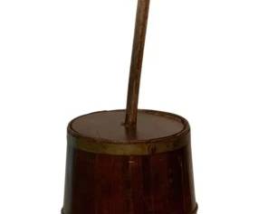 191 - Antique Wooden Butter Churn 42"x12" (Description): Antique wooden butter churn featuring a tapered stave-constructed body with brass banding at intervals for stability. The piece displays a rich, warm brown patina consistent with age and use. Measures 42 inches in height by 12 inches in diameter.