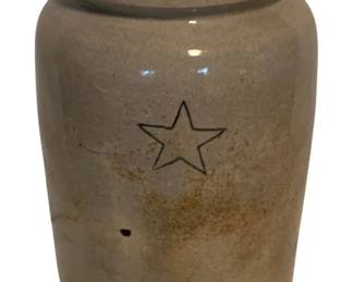 18 - Stoneware Crock w/ Star Design 10"x6" (Description): Antique stoneware crock featuring an incised star design on the front. The crock has a salt-glazed finish in a cream or tan color with natural variations and patina. Sold as-is with a chip noted. Measures 10 inches tall by 6 inches in diameter.