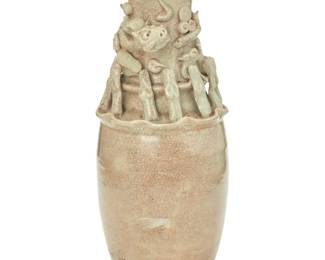 1285 A Chinese celadon glazed pottery hunping funerary urn Song/Yuan Dynasty (960-1368) or later Applied with a border of twelve standing figures and a striding dragon in relief around the neck 12.5" H x 4.625" Dia. Estimate: $200 - $300