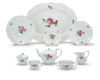 1011 A Meissen porcelain 'Rose Pink' dinner and tea service Late 20th century Each with underglaze blue cross swords and marked in red: 020110; variously impressed for pattern and shape Comprising: 12 dinner plates (9.875") 12 salad plates (7.875") 12 bread & butter plates (6.125") 12 salad bowls (6.75") 24 fruit bowls (5.375") 12 flat cups (2.5" H) 12 handled soup bowls (2.25" H) 1 hot water pot (7.875" H) 1 teapot (5.25" H) 1 creamer (4.375" H) 1 lidded sugar (3.75" H) 1 large serving platter (17.5" W x 13.75" D) 1 oval platter (10.875" W x 7.75" D) 1 square vegetable serving bowl (9.25" W x 9.25" D) 1 square shallow dish (7.125" W x 7.125" D) 1 reticulated bowl (9.375") 1 reticulated compote (8.25") 1 gravy/sauce boat with attached underplate (10.25" W x 6.5" D) 4 small vases (4.25" H) 1 taller bud vase (7" H) 2 candlesticks (6" H) 2 leaf-form dishes (5" W x 4" D) 116 pieces Estimate: $400 - $600