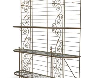 1162 A French baker's rack Early 20th century Brass and metal alloy, with laddered back and three tiers of removable wire shelving between two scroll supports 94.75" H x 79.25" W x 20" D Estimate: $300 - $500