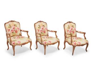 1191 A set of three Louis XV carved walnut fauteuils Mid-late 18th century with later elements Each wood armchair with carved foliate accents and scroll armrest terminals, the seatback, seat cushion, and armrests upholstered in a floral pattern fabric 3 pieces Each: 39" H x 30" W x 29.5" D Estimate: $400 - $600