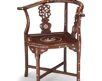 1310 A Chinese inlaid carved rosewood corner chair 20th century With yolk back and mother-of-pearl floral motifs throughout, raised on four legs joined by an X-stretcher 32.75" H x 27.25" W x 21.75" D Estimate: $200 - $400