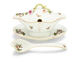 1013 A Herend porcelain 'Rothschild Bird' covered gravy boat on stand and ladle Late 20th century Each with blue printed factory mark and numbered 238 or 240 With attached underplate 2 pieces Gravy boat: 6.125" H x 9.5" W x 6.75" D; Ladle: 9.25" L Estimate: $300 - $500