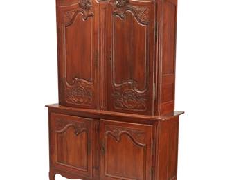 1161 A Louis XV Provincial buffet a deux corps 18th/19th century Surmounted by a scroll cornice, the upper section with paneled cabinet doors, opening to reveal a later lined interior and two shelves, the lower section with hinged doors enclosing a single shelf, raised on front scroll and rear square feet Lower: 39" H x 58.5" W x 21" D; Upper: 57.25" H x 55" W x 18" D; Overall: 96.25" H Estimate: $300 - $500