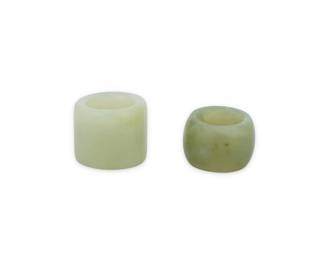 1308 Two Chinese hardstone archery thumb rings 20th century or earlier 2 pieces Larger: 1.25" H x 1.375" Dia., inner 0.875" Dia.; Smaller: 1" H x 1.375" Dia., inner: 0.75" Dia. Estimate: $100 - $200