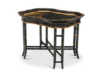 1109 A Contemporary japanned tray on stand Late 20th/early 21st century The ebonized wood tray with gilt-painted landscape decoration, raised on a bamboo-form stand 2 pieces Tray: 2.25" H x 30.5" W x 23.625" D; Stand: 21" H x 26.75" W x 20.5" D Estimate: $200 - $400