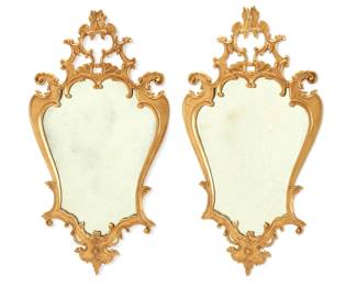 1100 A pair of Louis XV style giltwood mirrors 20th century The frames each with scrollwork and foliate accents 2 pieces Each: 47.25" H x 25.25" W x 2" D Estimate: $500 - $700