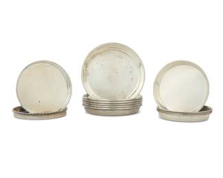 1004 A group of twelve sterling silver trays Mid-20th century Each marked for sterling; six marked: S. KIRK & SON; the other six marked: PP [Petersen, Ontario] Comprising a set of six, a set of four, and a pair 12 pieces Largest: 3.625" Dia.; Smallest: 3" Dia. Total weight: 13.9 oz. troy approximately Estimate: $500 - $700