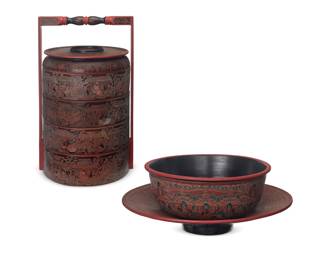1330 A Burmese lacquered wood food box and two bowls 20th/21st century; Bagan, Myanmar Each marked to underside: The Lotus Collection Comprising a four-tiered food box with carrying handle, a footed low bowl with repeating beast motif, and another bowl depicting figures in a village 3 pieces Box overall: 28.5" H x 16.5" W x 15.5" D; Footed: 4" H x 20.25" Dia.; Bowl: 5.75" H x 15" Dia. Estimate: $200 - $400