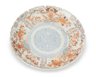 1324 A Japanese Imari Ninshiki style enameled porcelain charger Late Edo Period (1603-1868) or later Unmarked Overall polychrome decorated with foliate and geometric ornament with gilt accents and blue geometric motifs to the reverse 2" H x 12.25" Dia. Estimate: $200 - $300