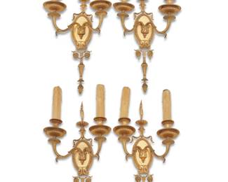 1102 A set of four Louis XVI style gilt bronze sconces Early 20th century With faux candle fixtures, electrified 4 pieces Each: 22.25" H x 11" W x 6.5" D Estimate: $1,000 - $1,500
