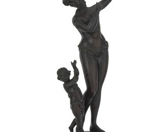 1053 A French patinated bronze figural group of a Maenad and baby satyr Late 19th/early 20th century Unmarked Raised on a composition base Bronze: 20" H x 7.25" W x 5" D; Overall: 21.5" H x 7.25" W x 6" D Estimate: $300 - $500