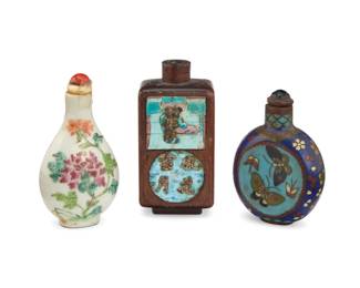 1276 Three Chinese snuff bottles 20th century Comprising one porcelain decorated with floral motifs, another carved wood with inset enameled panels and metal inlay, and the last a cloisonné bottle depicting butterfly motifs 3 pieces Porcelain: 3.125" H; Wood: 3.125" H x 1.5" W x 1.375" D; Cloisonné: 2.75" H Estimate: $250 - $350