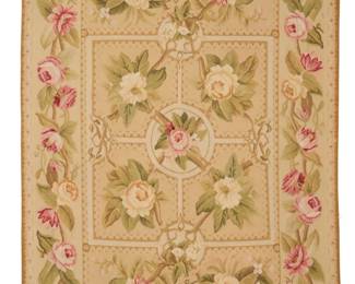 1370 An Aubusson floral area rug Early/mid-20th century A polychrome rectangular flat weave wool needlepoint style tapestry rug featuring a central geometric 'parterre' motif with floral branches and fine geometric edging, surrounded by a twined floral border to all sides 75" H (loom width) x 47.5" W Estimate: $200 - $400