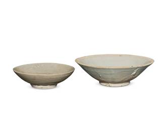 1337 Two Southeast Asian celadon ceramic bowls 15th century or later Each with bisque foot 2 pieces Larger: 2.125" H x 6.875" Dia.; Smaller: 1.625" H x 5.25" Dia. Estimate: $200 - $300