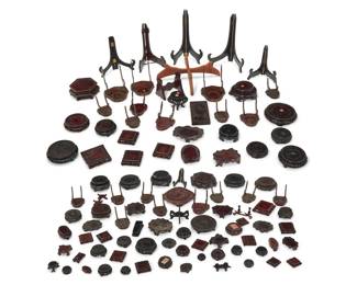 1277 A large group of Asian hardwood stands 20th century Comprising various folding frame stands, Asian-style display bases, plate stands, and more Approximately 95 Various sizes and dimensions Estimate: $300 - $500