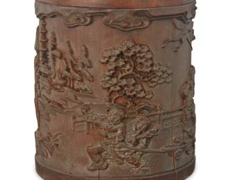 1265 A Chinese carved bamboo brush pot 20th century Carved with figures within a village scene 6.625" H x 5.5" Dia. (irregular) Estimate: $100 - $200