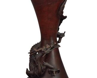 1350 A Japanese bronze dragon vase 20th century With impressed seal mark to underside The hourglass vase with applied dragon form to conical vase 9.375" H x 4.5" W x 4.25" D Estimate: $100 - $200