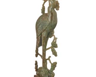 1303 A Chinese jade carving of a Manchurian crane 20th century Raised on a carved hardwood stand Figure: 10.25" H x 3.625" W x 2.5" D; Overall: 11" H Estimate: $400 - $600