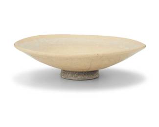 1284 An Asian style pale yellow glazed ceramic bowl 20th century With illegible incised signature to underside foot and dated, reading '47' or '97' Of shallow footed form 2" H x 7" Dia. Estimate: $300 - $400
