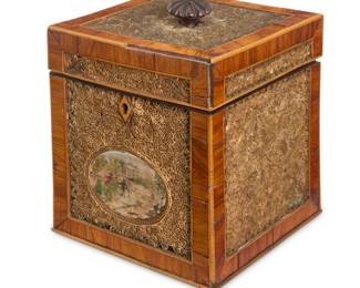 1123 A George III rolled paper tea caddy Late 18th/early 19th century With painted fabric panel at front below a locking lid, the exterior inset with rolled paper filigree and floral designs 6.125" H x 5" W x 5" D Estimate: $700 - $900