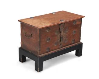 1130 A Dutch Colonial hardwood coffer 19th century With iron locking mechanism, opposed handles, and mounted accents, set on a later ebonized wood stand Coffer: 11.25" H x 23.5" W x 12.25" D; Stand: 6" H Estimate: $100 - $200