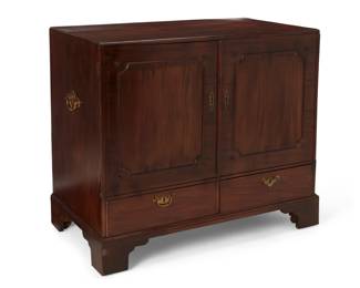 1122 A George III style mahogany cabinet 20th century Enclosed by a pair of cupboard doors, opening to reveal four sliding shelves, above two short drawers, flanked by handles, raised on bracket feet with wood casters 38.25" H x 43.5" W x 23.75" D Estimate: $200 - $400