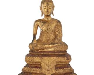 1333 A Burmo Thai gilt metal Buddha figure Rattanakosin Period (1782-1932) With inset glass accents, depicted with hands in bhumisparsha mudra, seated on a tiered base 15.25" H x 10.5" W x 6.375" D Estimate: $300 - $500