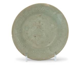 1355 A Korean celadon ceramic dish Goryeo Period (918-1392) or style Molded with floral motifs at interior border 1.5" H x 5.375" Dia. Estimate: $300 - $500