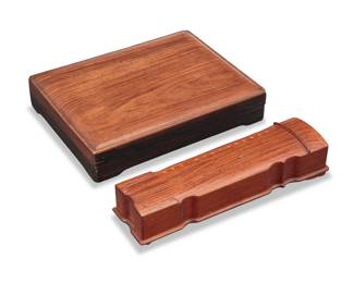1260 Two Chinese hardwood lidded boxes Late Qing Dynasty/Republic Period (1644-1949) or later Comprising one rectangular box of keyed miter construction, and another shaped like a guqin instrument, inlaid with brass "strings" and accents 2 pieces Rectangular: 2.375" H x 12" W x 9.125" D; Guqin: 2.625" H x 12.125" W x 3.5" D Estimate: $400 - $600