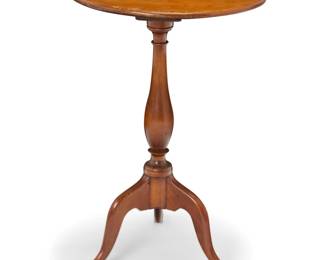 1188 A Queen Anne mahogany tea table Mid-18th century The oval top raised on a turned standard and tripod base with sloping legs 27.5" H x 19" W x 18" D Estimate: $300 - $500