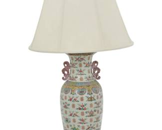 1271 A Chinese Famille Rose porcelain vase as a lamp 20th century With bat-form handles, decorated with bundles of nine peaches and floral motifs, mounted as a table lamp with single light, surmounted by a fabric shade, electrified Vase: 17.5" H x 8.5" Dia.; Lamp without harp: 22.5" H x 9" W x 9" D; Shade: 12.75" H x 20.5" Dia. Estimate: $300 - $500