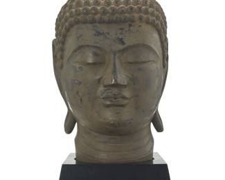 1295 An Asian style carved wood head of Buddha 20th/21st century Antiqued enameled hardwood raised on a wood base Head: 9.25" H x 11.5" W x 13.5" D; Base: 4.25" H x 11" W x 12" D Estimate: $300 - $400