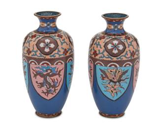 1349 A pair of Japanese cloisonné vases Meiji Period (1868-1912) Each of baluster form with brass rim and decorated with polychrome armorials and floral motifs on a blue and peach ground 2 pieces Each: 7" H x 3.5" Dia. Estimate: $200 - $400