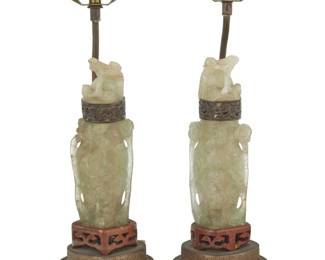 1305 A pair of Chinese carved hardstone table lamps 20th century Comprising two lidded urns, each depicting bird motifs and converted to a single-light lamp with a pierced gilt-metal base, electrified 2 pieces Each: 16.75" H x 5" Dia. Estimate: $300 - $500
