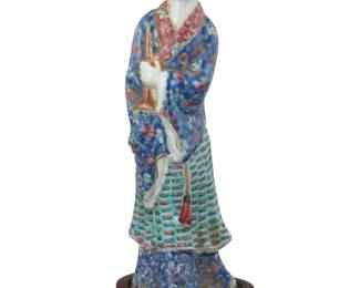 1282 A Chinese polychrome porcelain figure of a beauty Late Qing Dynasty/Republic Period (1644-1949) Stand with incised mark and impressed: China Raised on a carved hardwood stand Overall: 8.25" H x 3" W x 2.625" D Estimate: $300 - $400