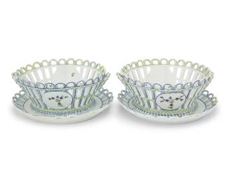1126 A pair of Niderviller porcelain baskets and underplates Late 18th century Each element but one basket bearing a blue underglaze cipher to underside With latticework rims, opposed handles, and decorated with floral motifs, each set on a matching underplate 2 pieces Each overall: 4" H x 9.75" Dia. Estimate: $250 - $350