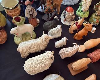 Collection of Ceramic and Wooden Figurines including Staffordshire Sheep, Nativity Figures, and Character Jugs