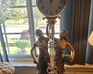 Brass clock of two women