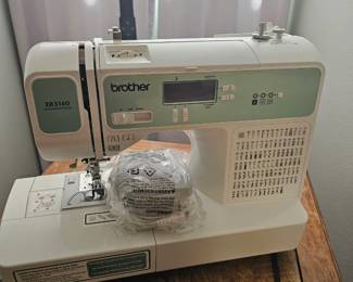 Nearly new Brother sewing machine with box and a few attachments
