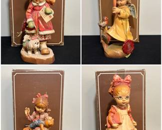 A collection of vintage ANRI Sarah Kay hand-carved wooden figurines from Italy.