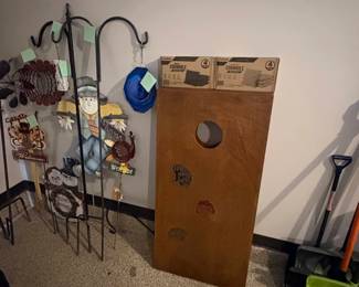 Cornhole boards with bean bags and outdoor garden decor