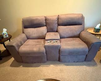 Power reclining leather love seat with adjustable head rest feature, 3 years old