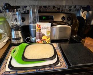 Ninja blender, blender, cutting boards, toaster and misc kitchen items