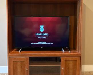 Entertainment center with flat screen TCL tv