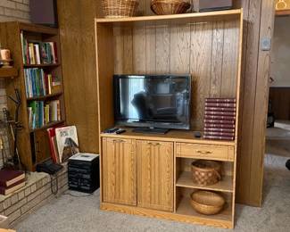 TV, cabinet, baskets, books