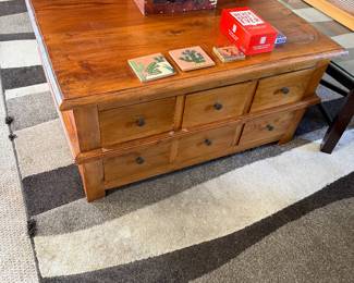 rustic, honey-toned solid wood multi-drawer coffee table