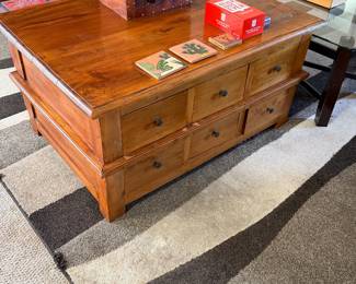 rustic, honey-toned solid wood multi-drawer coffee table