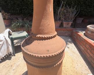 Mexican-style clay chiminea features a terracotta finish
